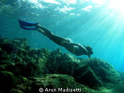 Snorkeler in the volcanic vents at Champagne by Arun Madisetti 
